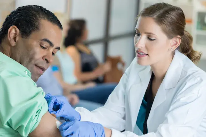 Woman giving a man a shot in the arm